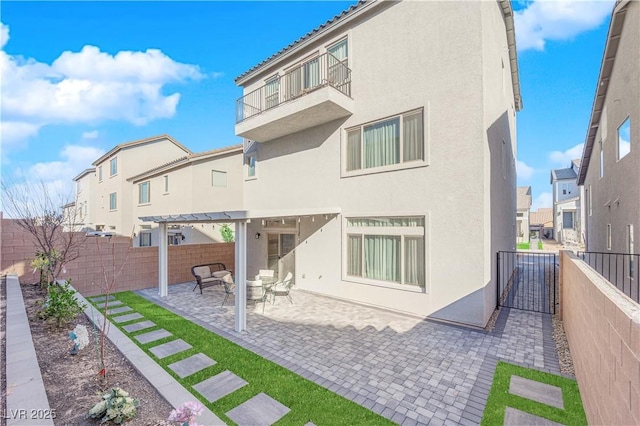 back of house with a balcony, a pergola, and a patio area