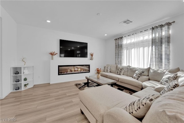 living room with light hardwood / wood-style flooring