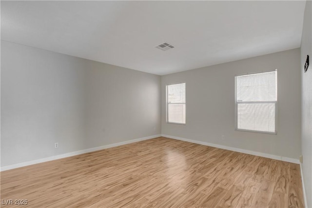 empty room with light hardwood / wood-style flooring