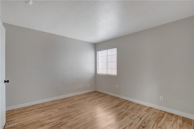 spare room featuring light hardwood / wood-style floors