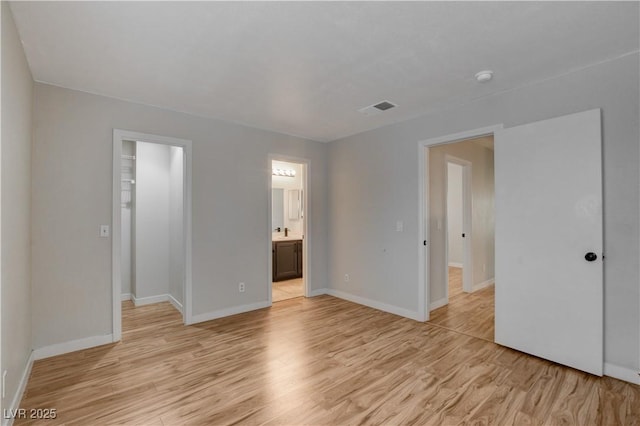 spare room with light hardwood / wood-style flooring