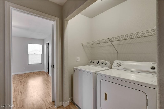 laundry room featuring washer and dryer and light wood-type flooring