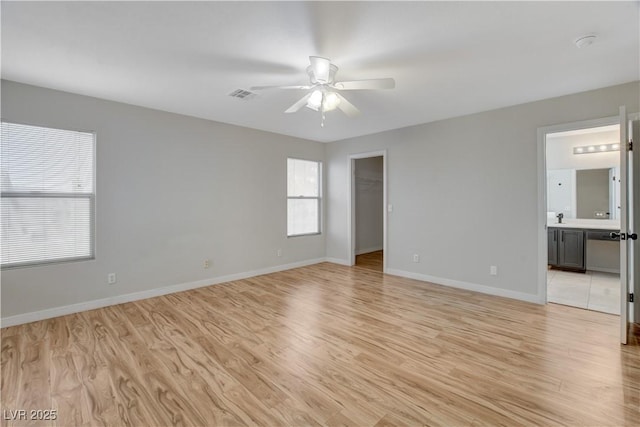 empty room featuring ceiling fan and light hardwood / wood-style floors