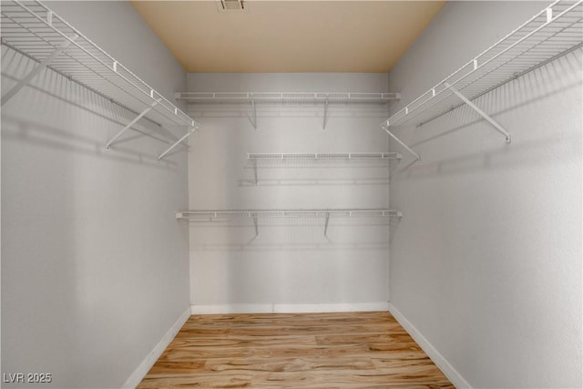 walk in closet featuring hardwood / wood-style floors