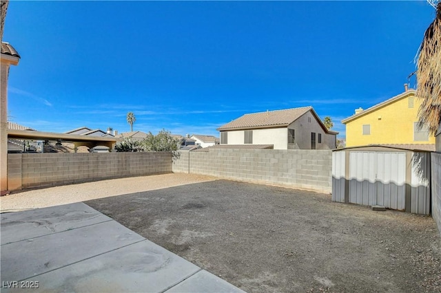 view of yard featuring a patio area and a storage unit