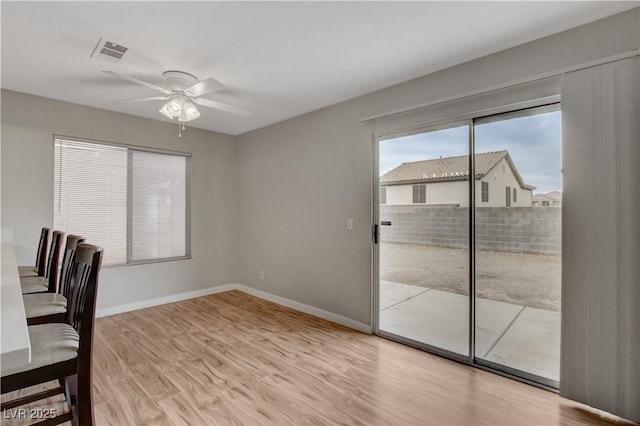 unfurnished office featuring ceiling fan and light hardwood / wood-style flooring