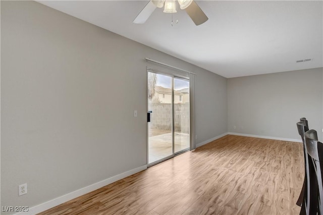 empty room featuring ceiling fan and light wood-type flooring