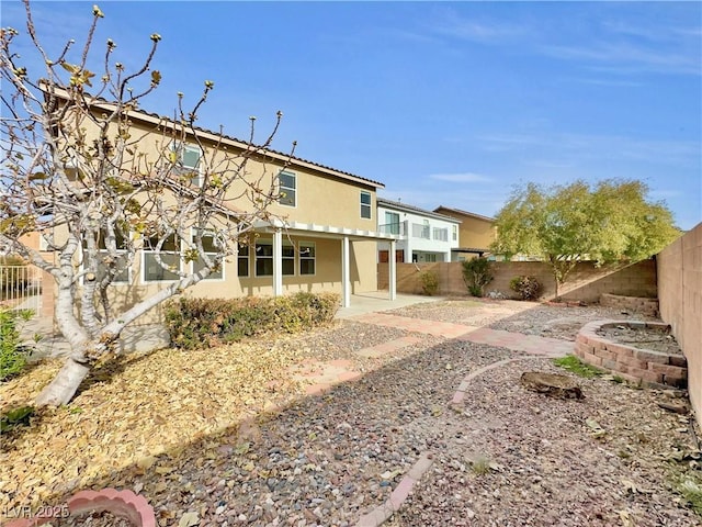 back of property with a patio