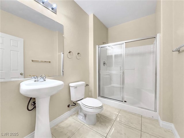 bathroom with sink, toilet, tile patterned flooring, and a shower with door