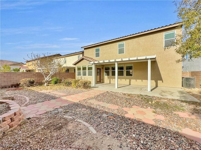 rear view of property featuring a patio area and central air condition unit