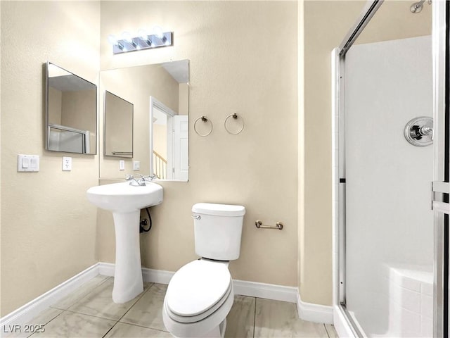 bathroom featuring a shower with door, tile patterned floors, and toilet