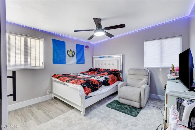 bedroom featuring a ceiling fan, light wood finished floors, and baseboards