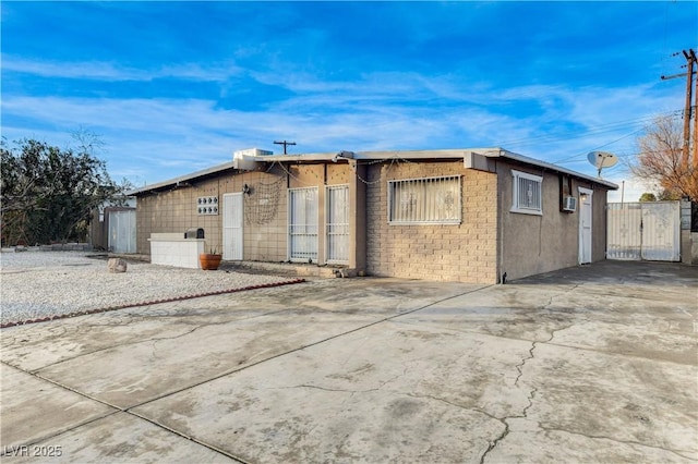 exterior space with concrete driveway and fence