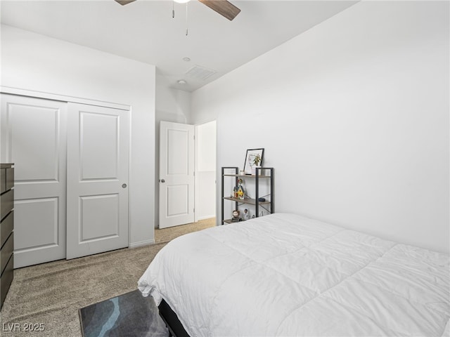 bedroom featuring ceiling fan, light carpet, and a closet