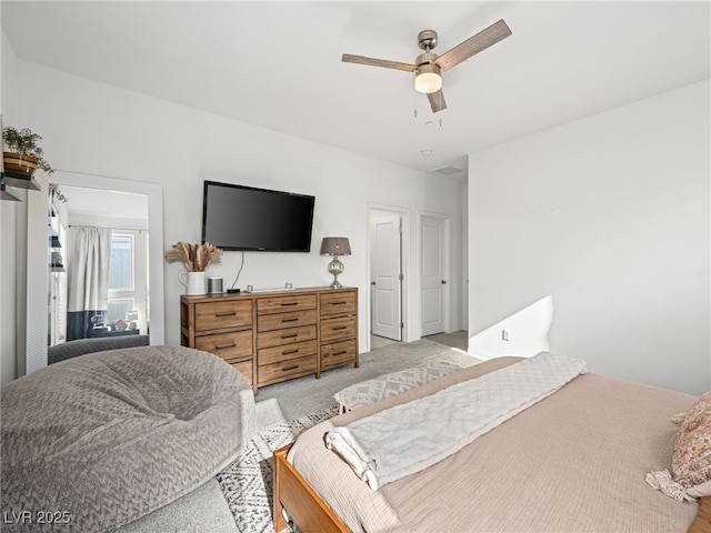 bedroom featuring light colored carpet and ceiling fan