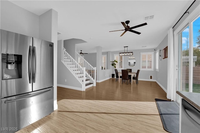 interior space with ceiling fan and wood-type flooring