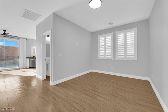 spare room featuring ceiling fan and light hardwood / wood-style flooring