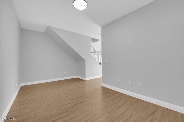 additional living space featuring light hardwood / wood-style flooring