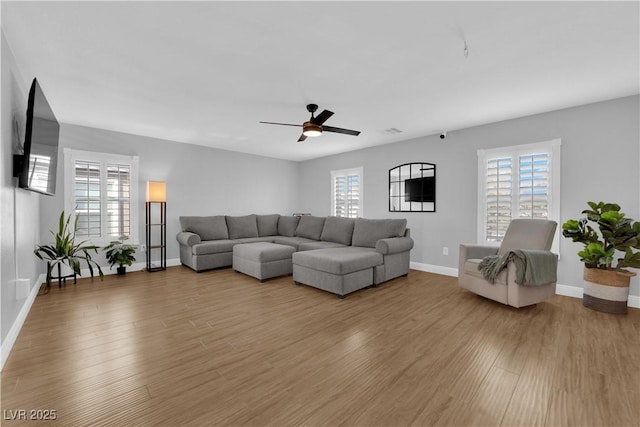 living room featuring hardwood / wood-style flooring and ceiling fan