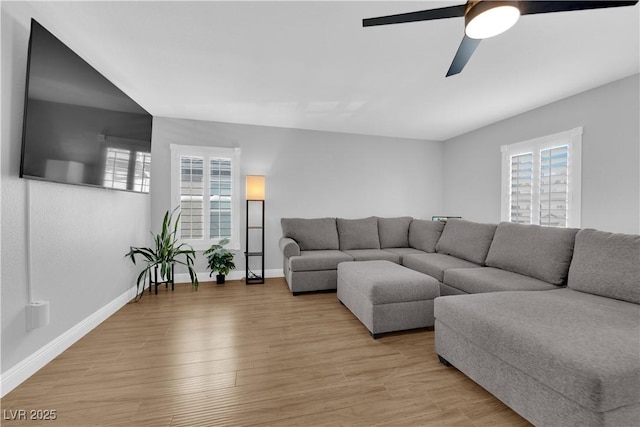 living room featuring ceiling fan and light hardwood / wood-style flooring