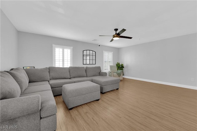 living room with ceiling fan and light hardwood / wood-style floors