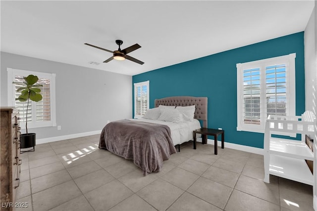 bedroom with ceiling fan and light tile patterned flooring