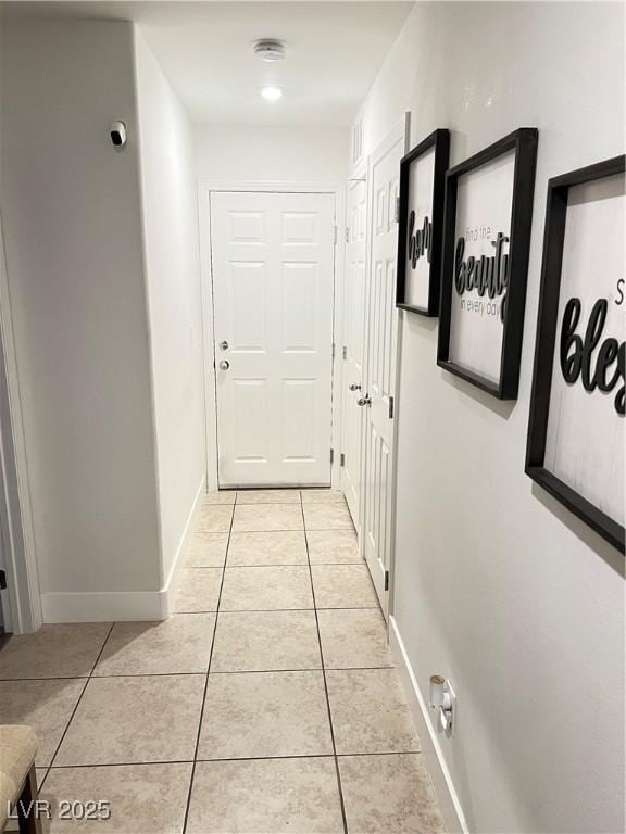 corridor featuring light tile patterned floors