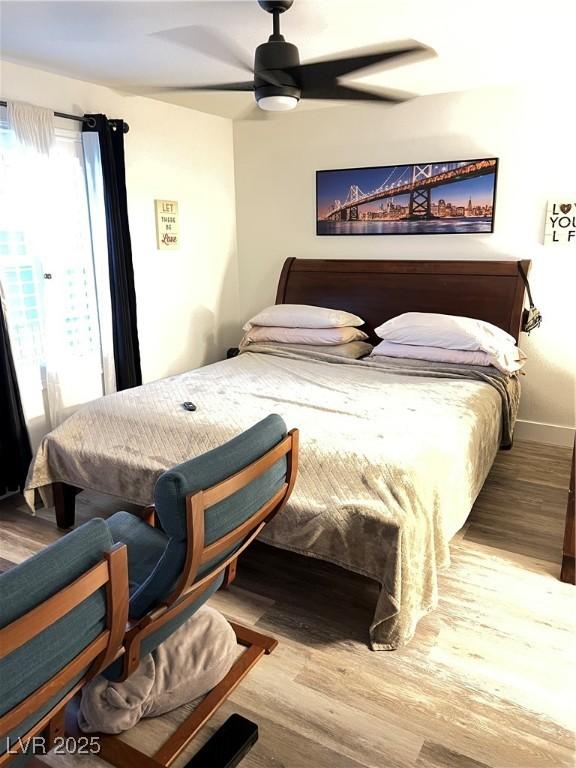 bedroom with ceiling fan and wood-type flooring