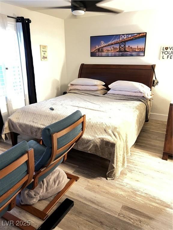 bedroom with ceiling fan and hardwood / wood-style floors