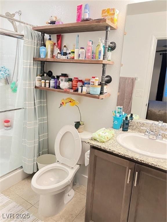 bathroom featuring tile patterned flooring, vanity, a shower with curtain, and toilet