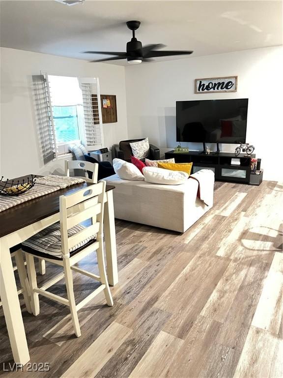 living room with hardwood / wood-style floors and ceiling fan