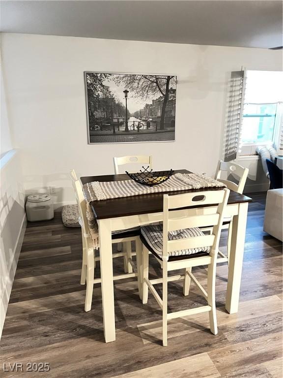 dining space with dark wood-type flooring