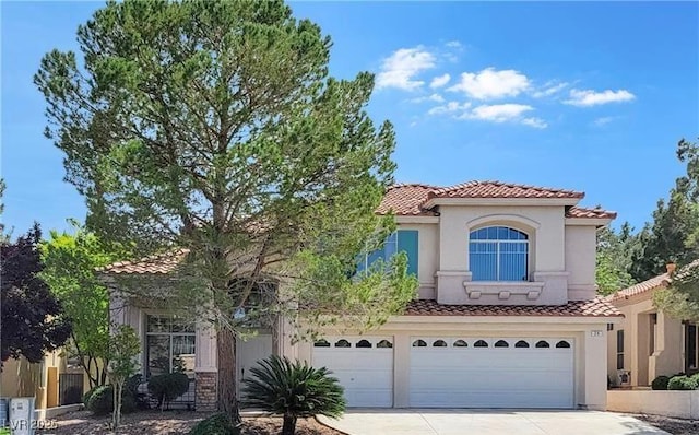 mediterranean / spanish-style home featuring a garage