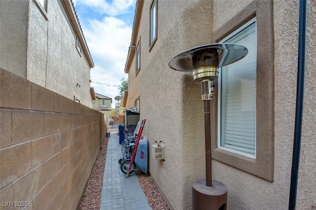 view of property exterior with fence and stucco siding