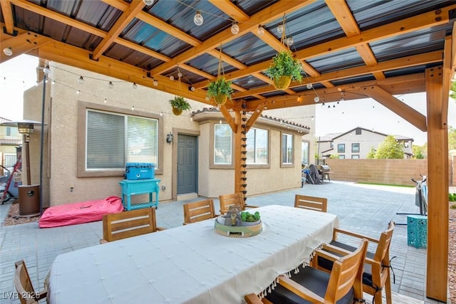 view of patio with outdoor dining space and fence