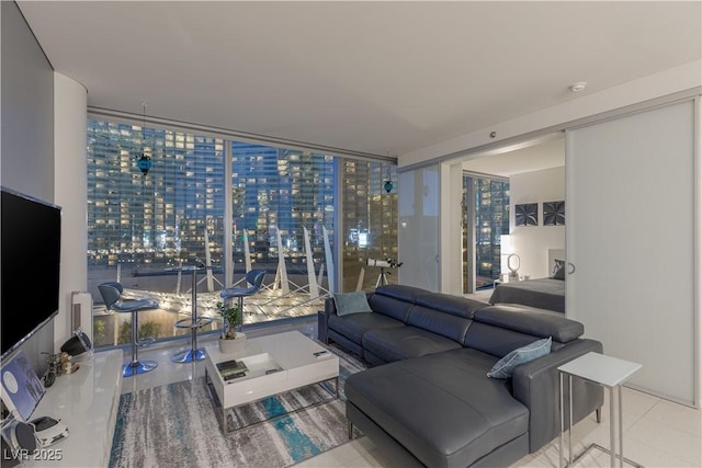 living room featuring light tile patterned flooring and floor to ceiling windows