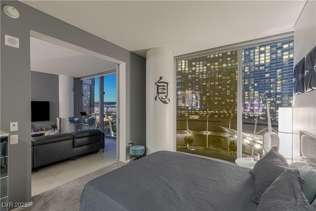 tiled bedroom featuring expansive windows