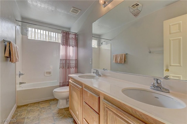 full bathroom with vanity, shower / bath combination with curtain, and toilet