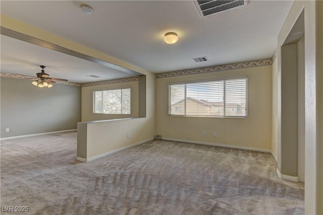 carpeted spare room with ceiling fan