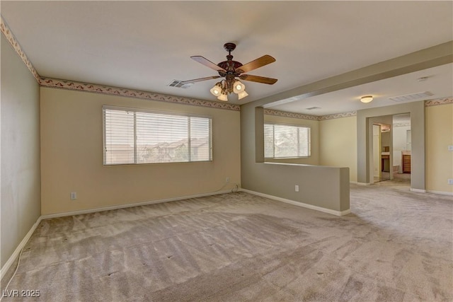 empty room featuring light carpet and ceiling fan