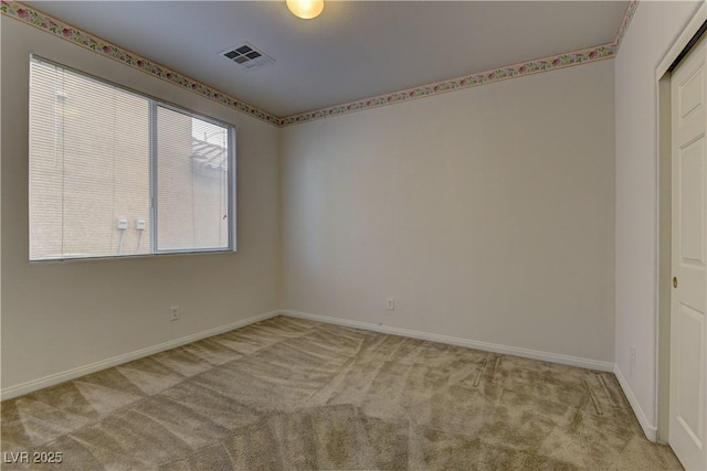 empty room featuring light carpet