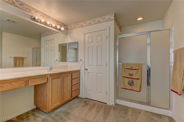 bathroom with vanity and an enclosed shower