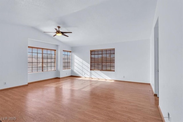 unfurnished living room featuring vaulted ceiling, light hardwood / wood-style floors, and ceiling fan