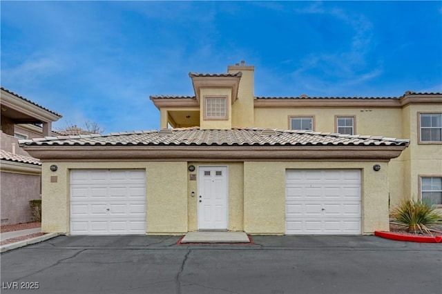 mediterranean / spanish-style house with a garage