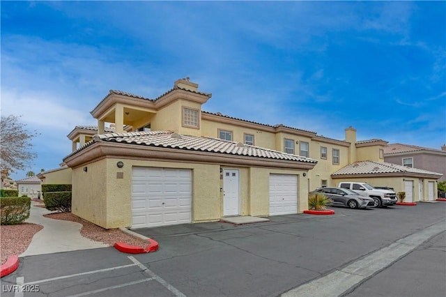 mediterranean / spanish-style home with a garage