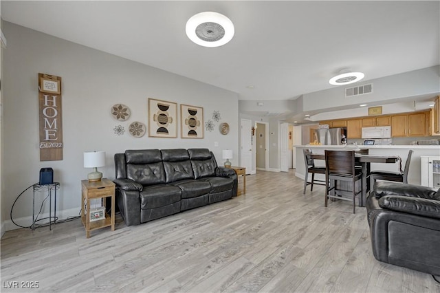 living room with light hardwood / wood-style floors