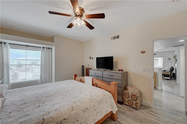 bedroom with ceiling fan and light hardwood / wood-style floors