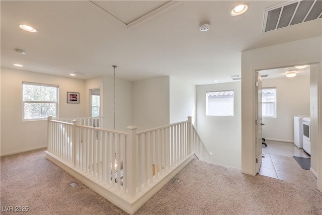 hall with an upstairs landing, visible vents, tile patterned flooring, and recessed lighting