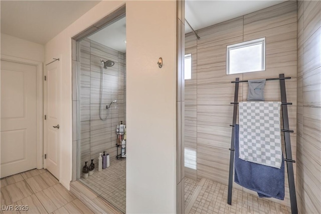 bathroom featuring tiled shower and tile patterned floors