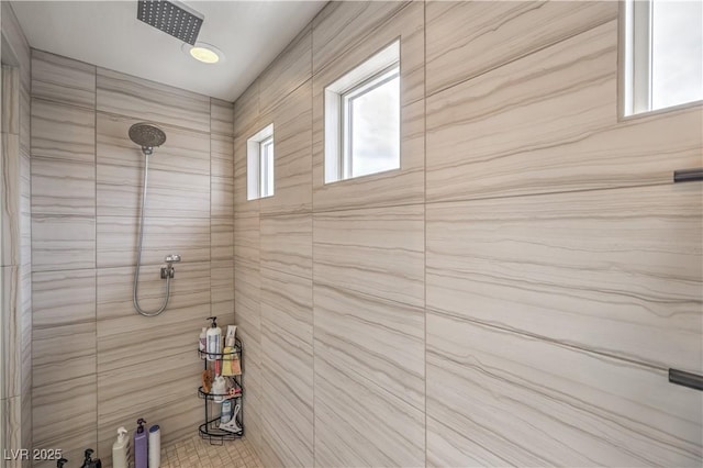 bathroom with a tile shower